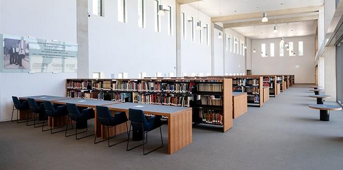Book shelves and tables and chairs in the Mandel archaeology library
